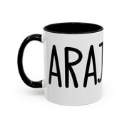 White accent coffee mug with black interior and handle featuring “Carajo” in black lettering on a white background.