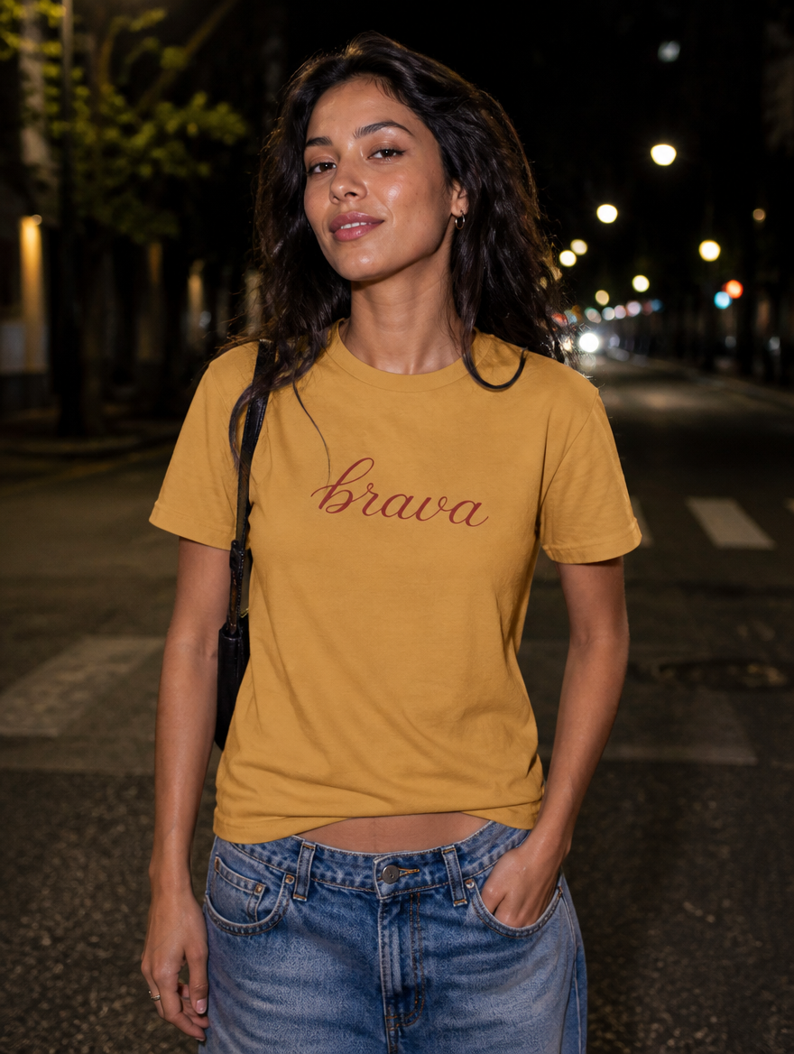Latina model wearing the Brava T-Shirt in Faded Mustard at night