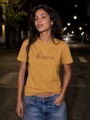 Latina model wearing the Brava T-Shirt in Faded Mustard at night