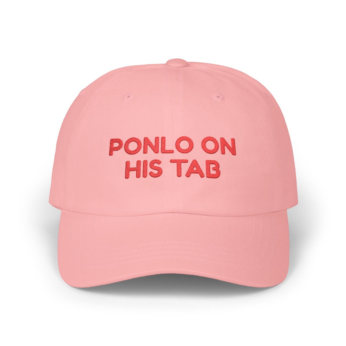 Pink dad cap with red “Ponlo on his tab” embroidery on a white background.