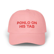Pink dad cap with red “Ponlo on his tab” embroidery on a white background.