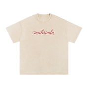 Apricot vintage-washed oversized T-shirt with red “malcriada” script text.