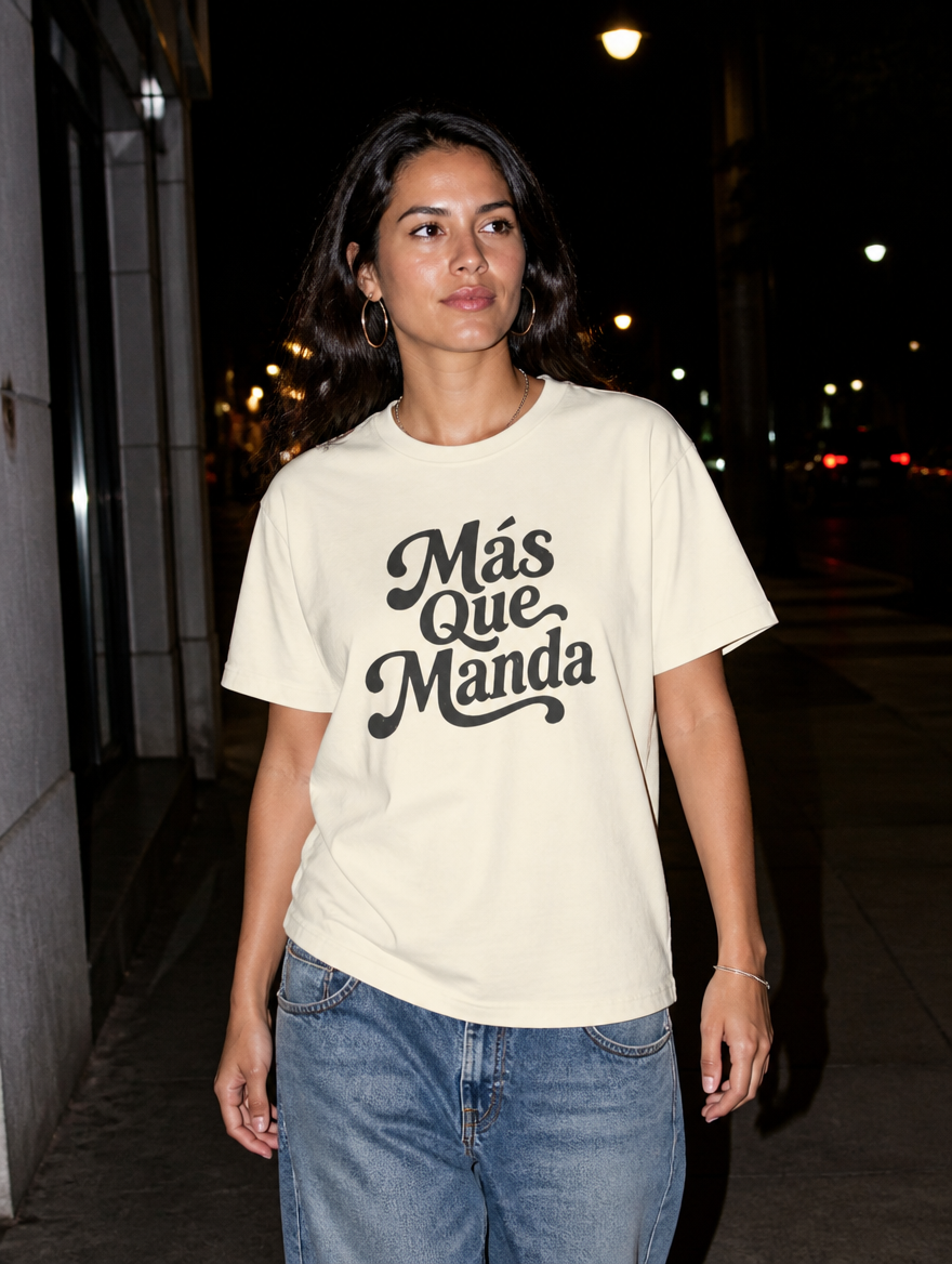 Latina model wearing the Más Que Manda T-Shirt in Faded Cream at night